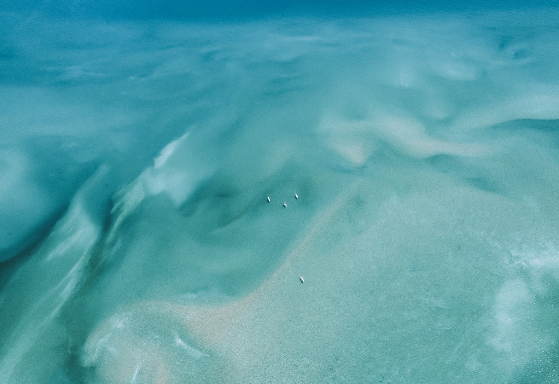 Aerial view of canoes on turquoise shallows
